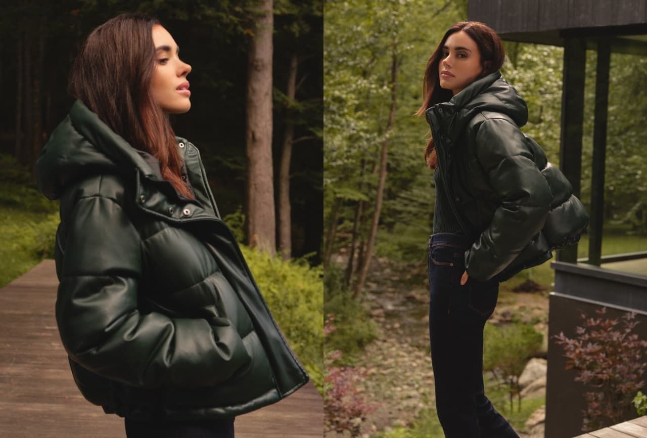 A model wears a forest green faux leather puffer jacket.