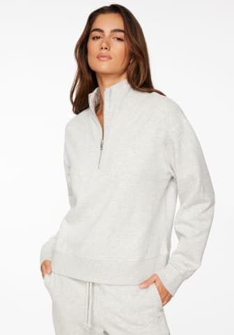 Model is wearing white zip up sweatshirt.