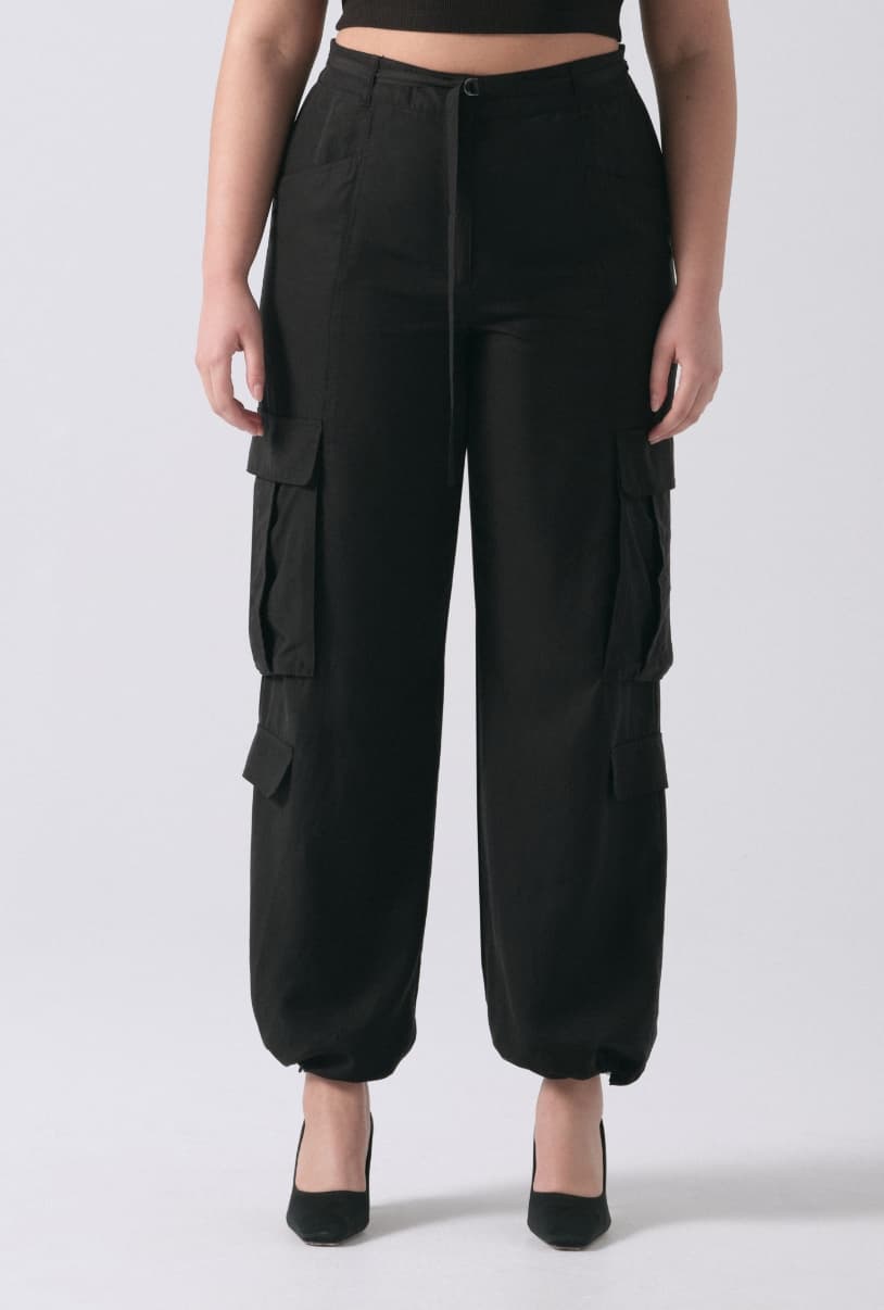 A model wears black cargo pants.