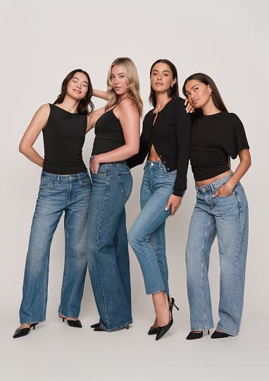 A group of models wearing black tops and blue jeans.