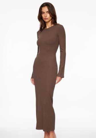 Model is wearing brown crewneck fitted maxi dress.