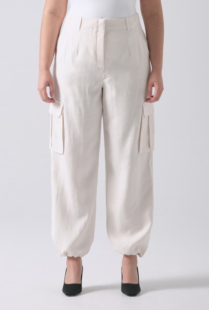 A model wears white cargo parachute pants.