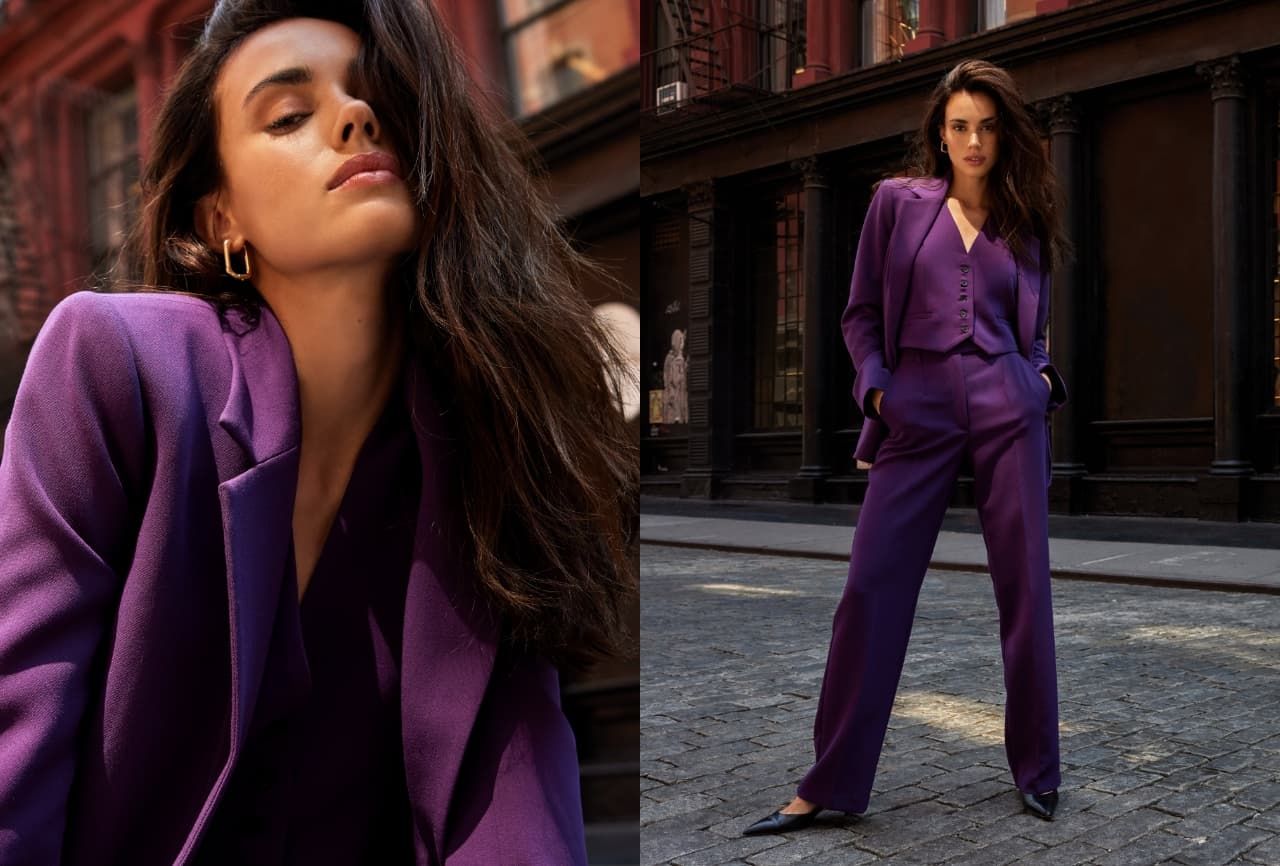 A model wears a three piece purple suit.