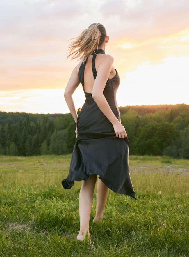 Nitsan wears the maxi open back satin halter dress.