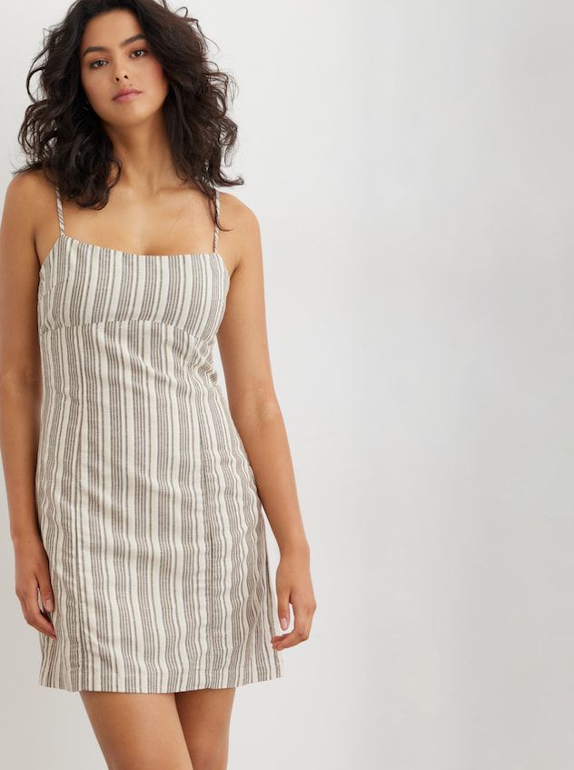 A model wears striped linen minidress.