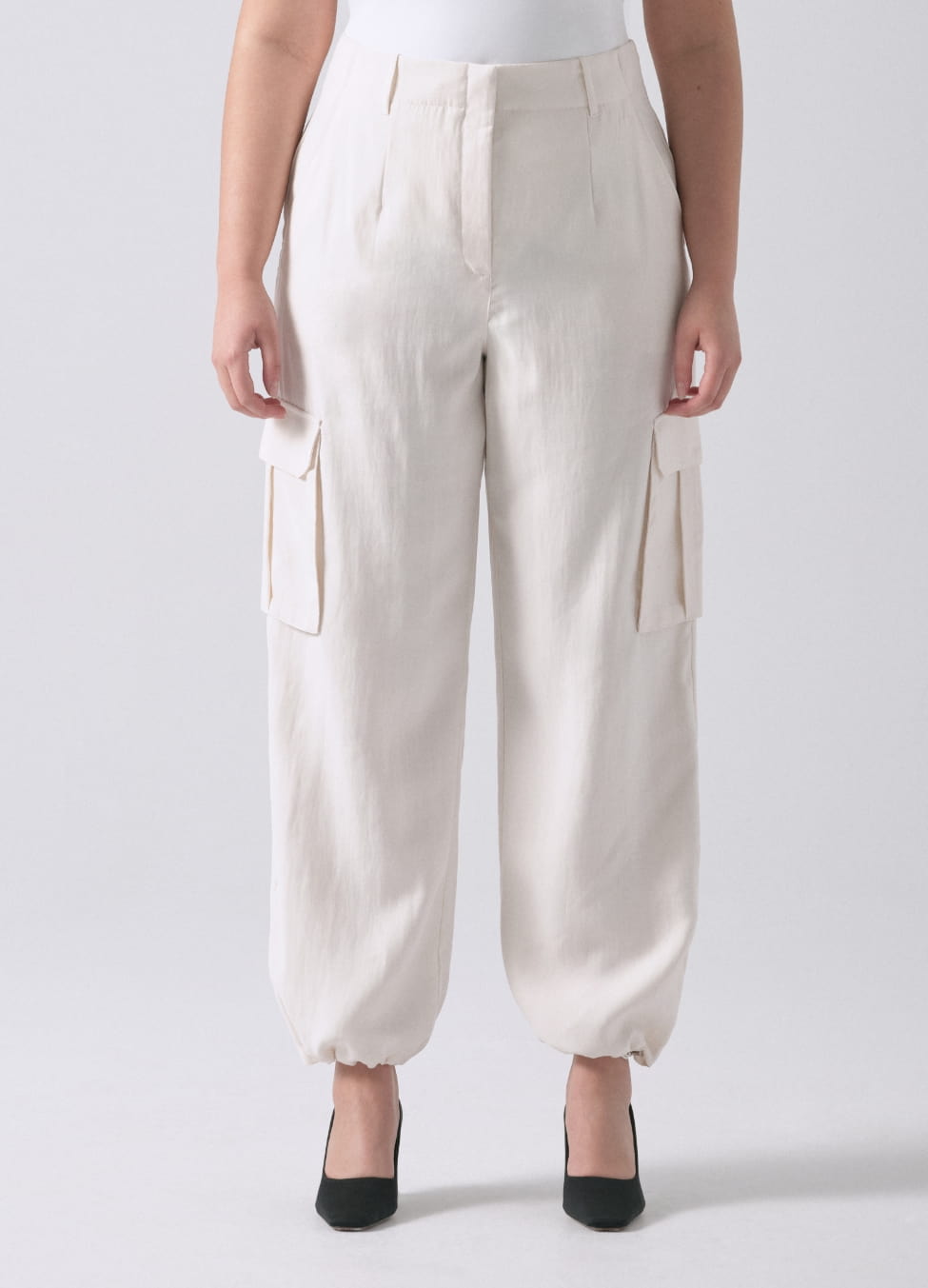 A model wears white cargo parachute pants.
