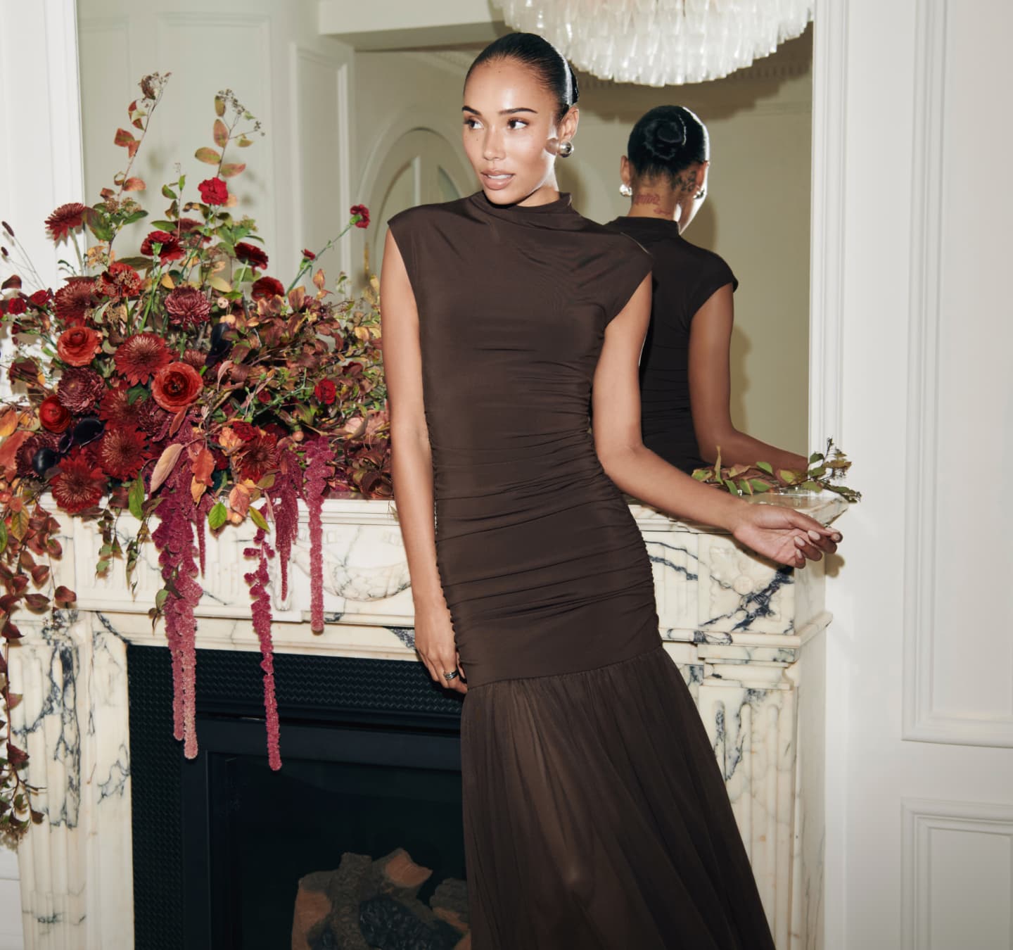 Model is wearing a brown satin dress.