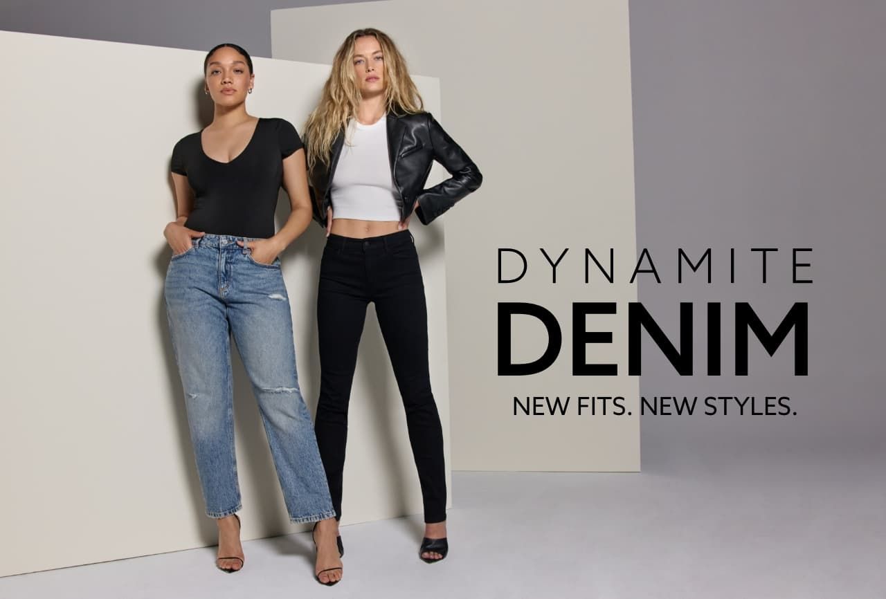 One model wears blue distressed slim straight leg jeans with a black v-neck bodysuit and the other model wears black skinny jeans with a white tank top and a faux leather moto jacket.