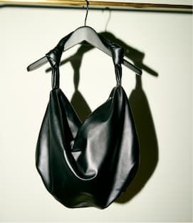 Oversized black knot bag on hanger.