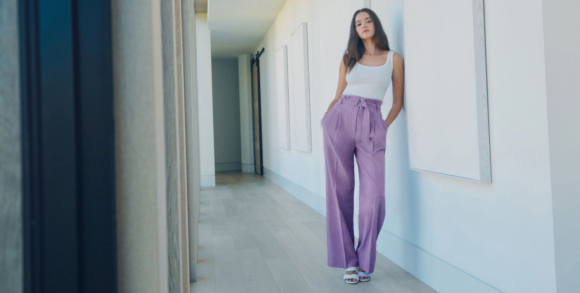 Valeria Lipovetsky wears a white ribbed tank with purple belted paperbag pants.