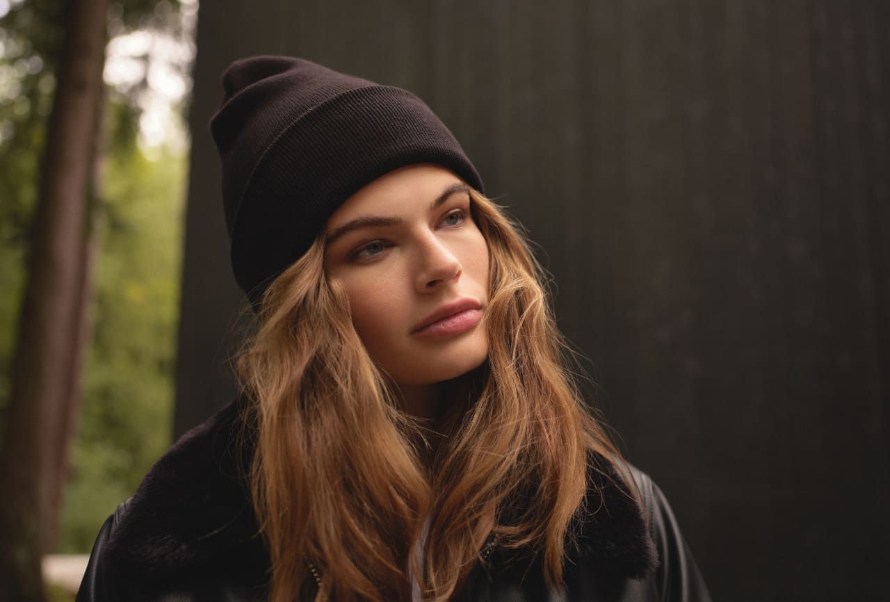 A model wears a black foldover tuque.