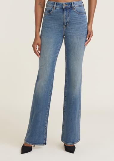 Model is wearing blue bootcut jeans.