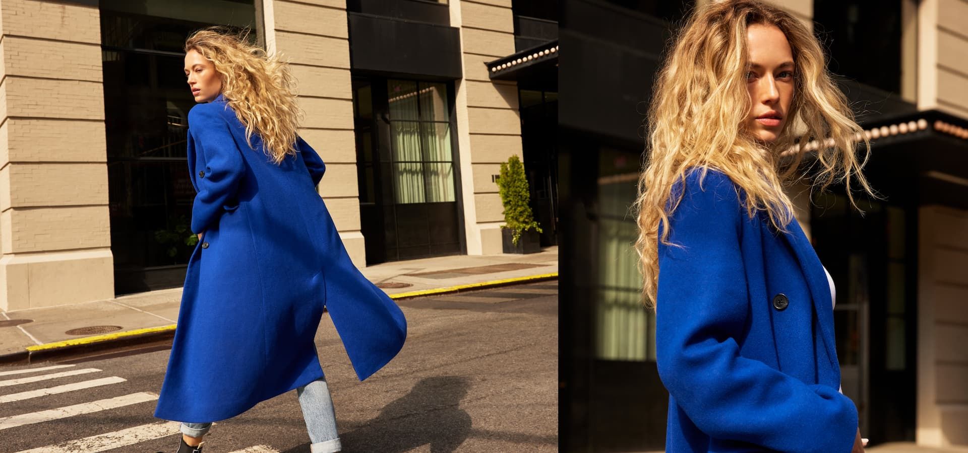 A model wears a bright blue coat over blue jeans.