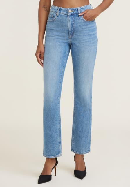 Model is wearing light blue slim leg jeans.