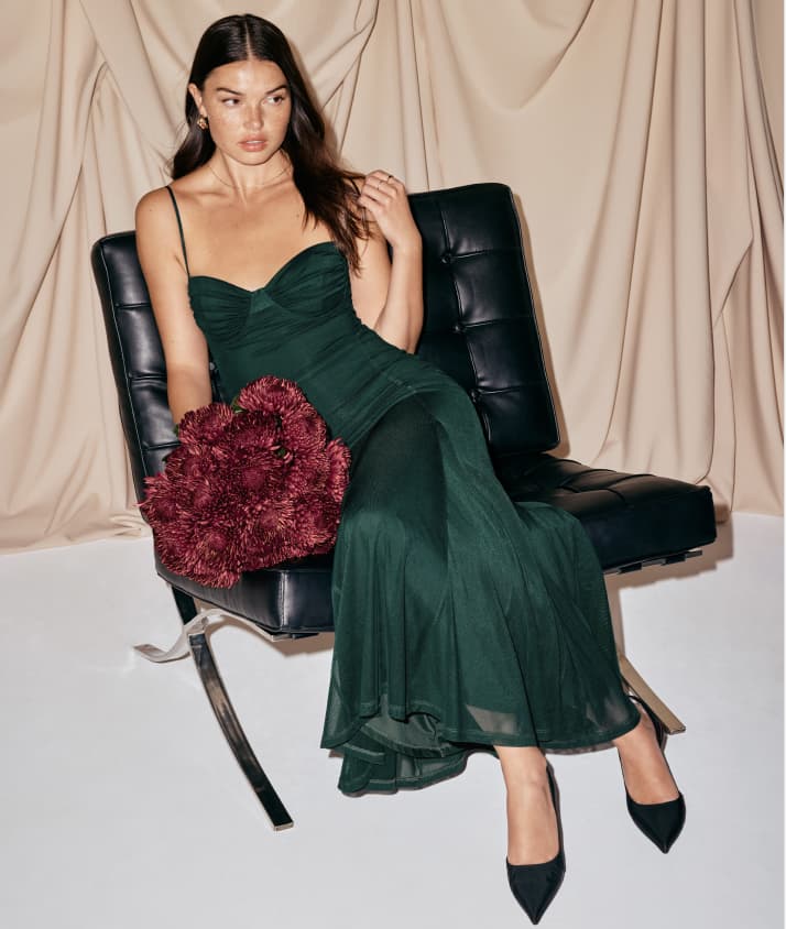 Model is wearing a green sweetheart maxi dress.