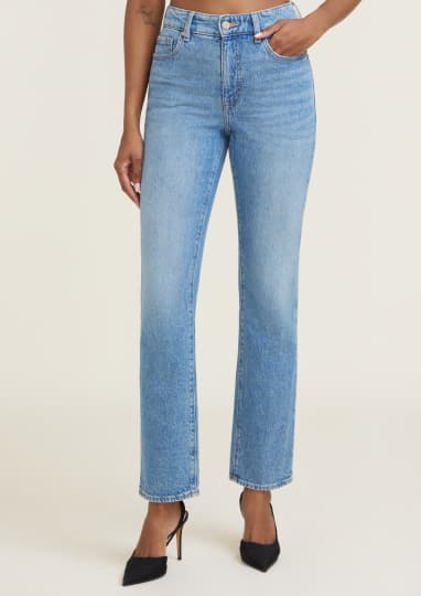 Model is wearing light blue slim leg jeans.