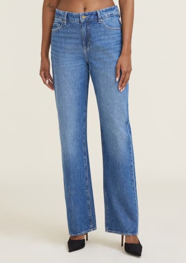 Model is wearing blue relaxed straight leg jeans.