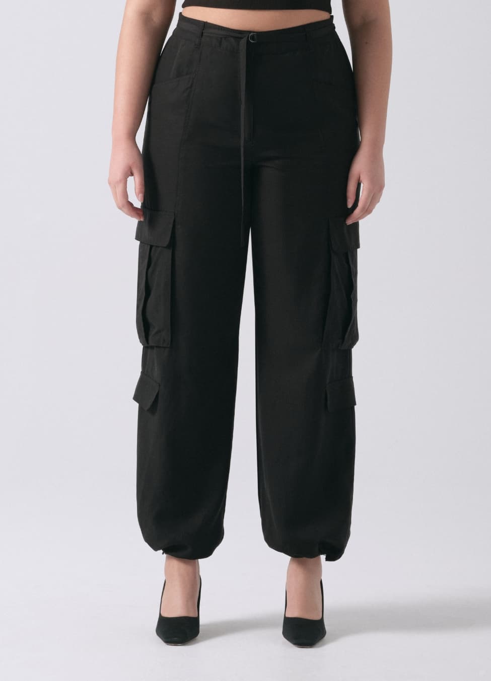 A model wears black cargo pants.