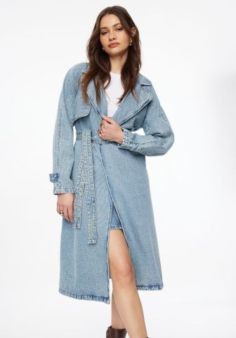 Model is wearing a denim trench coat with a white T-shirt and a denim mini skirt.