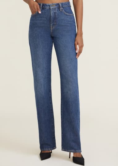 Model is wearing dark blue straight leg jeans.