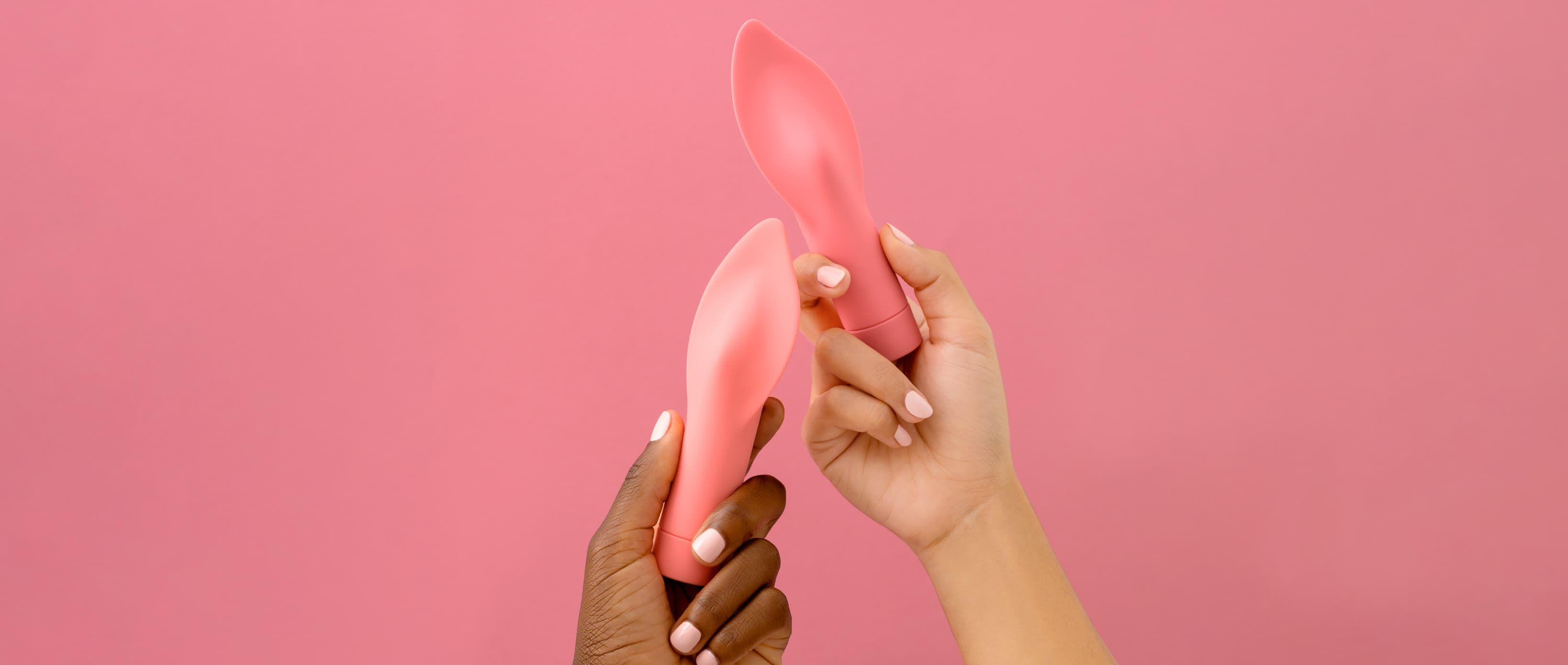 Models hold smilemakers vibrators against colourful backgrounds.