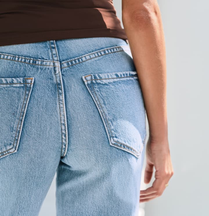 Model is wearing light blue jeans.