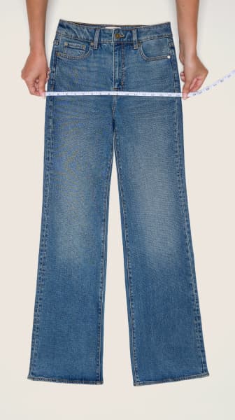 Place the measuring tape on the hips of a pair of jeans.