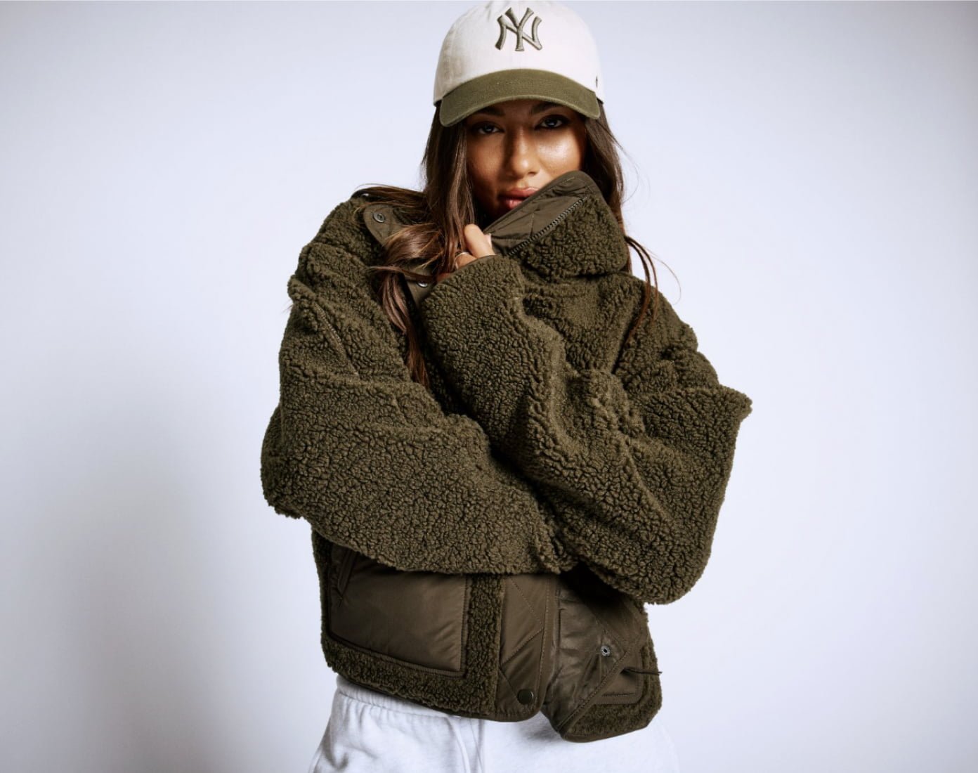 Sherpa fleece jackets, a black puffer vest, and a dark grey nylon bomber jacket. 