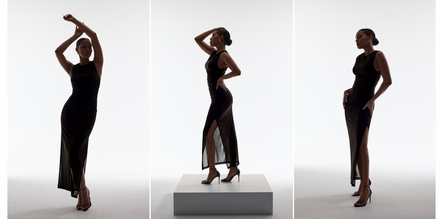 Model is wearing a black sheer mesh maxi dress.