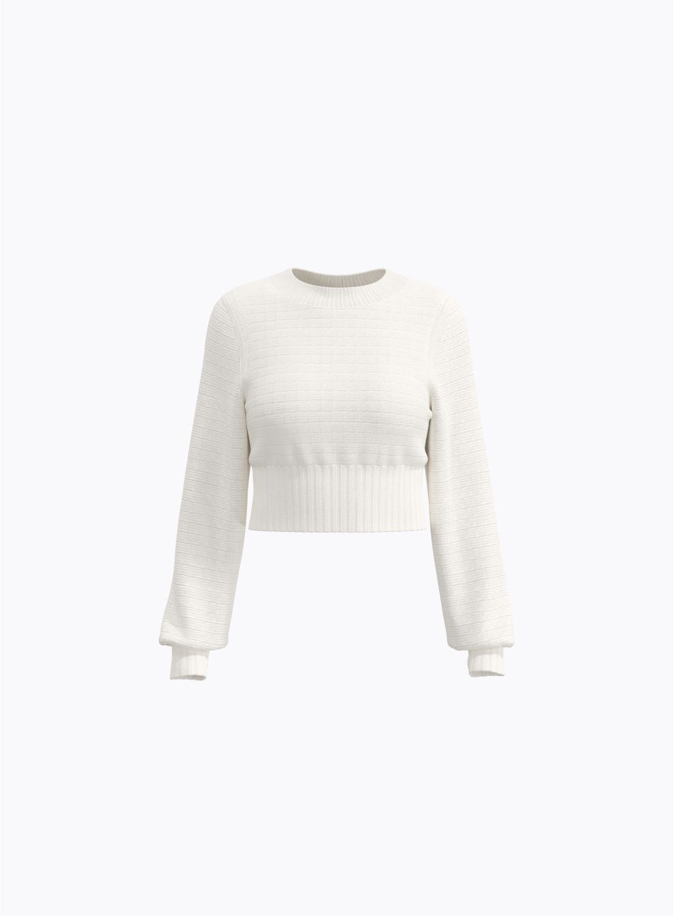 A beige cable knit sweater.