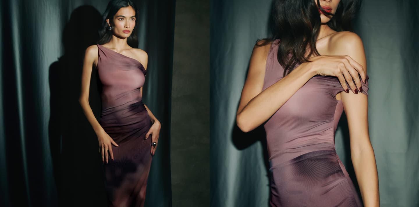 Model is wearing a printed purple maxi dress.