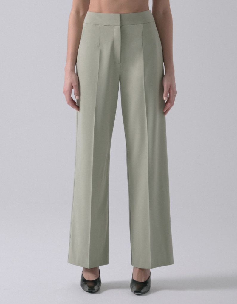 A model wears light khaki green straight leg pants.