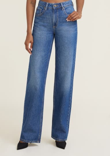 Model is wearing blue wide leg jeans.