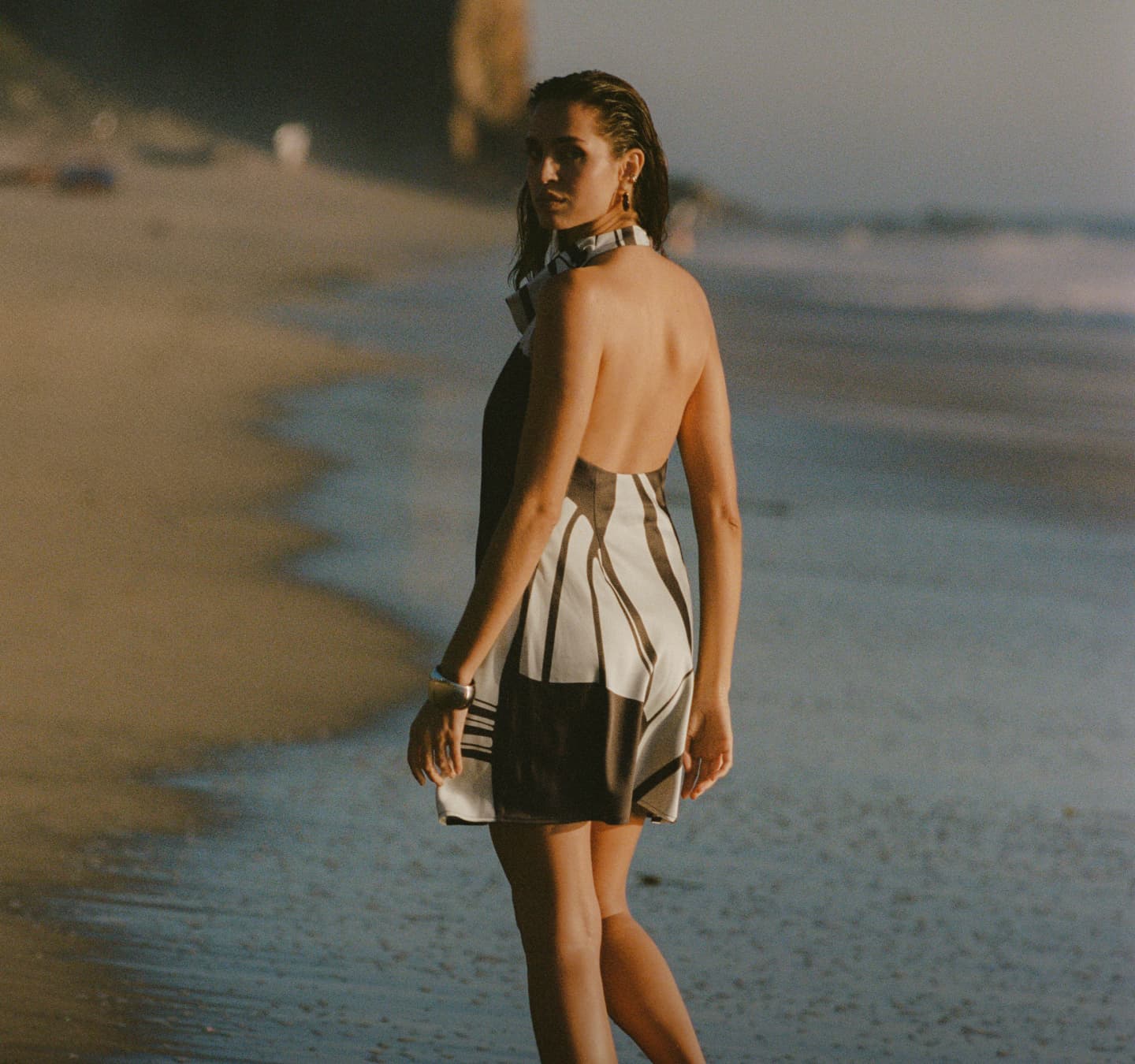 Model is wearing a brown and white printed top and skirt set.