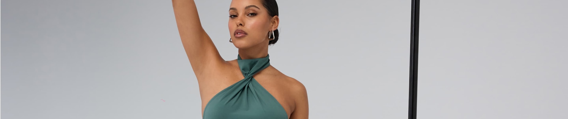 Model is wearing a blue twister halter neck bodysuit.